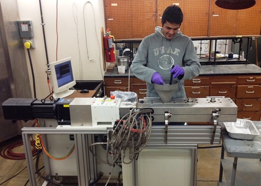 A student demonstrates extrusion equipment at the BMP lab